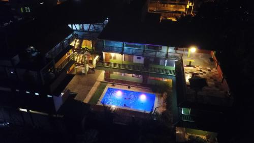 an overhead view of a building with a pool at night at Tambopata Hostel in Puerto Maldonado