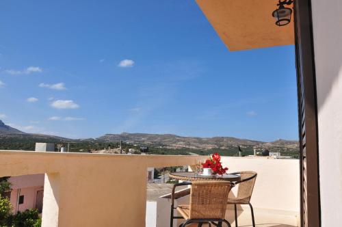 a balcony with a table and chairs and a view at House Margot in Palekastron
