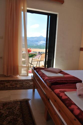 a bedroom with a bed and a large window at House Margot in Palekastron