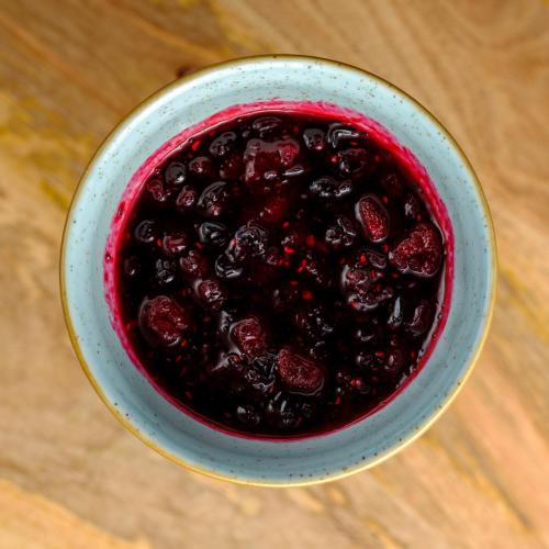 a bowl of blackberry jam on a wooden table at Acro Blue Luxury Villas in Akrotiri