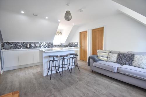 a living room with a couch and a kitchen at Birchwood in Skegness in Skegness