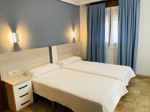 A bed or beds in a room at Hostal Labranza