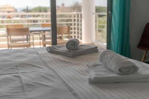 a bed with two towels on top of it at Armonia Studios Preveza in Preveza