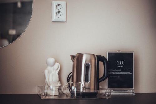 a coffee pot and a statue on a table at VIP apartments Bitola in Bitola