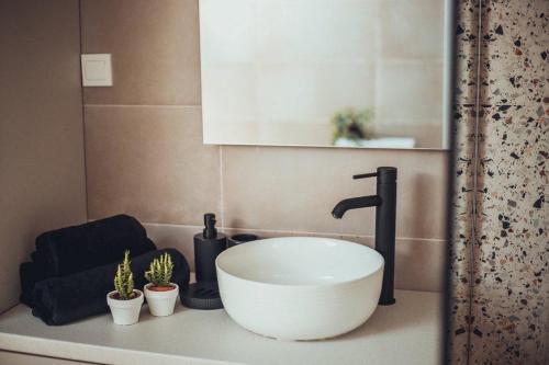 a bathroom counter with a sink and a faucet at VIP apartments Bitola in Bitola