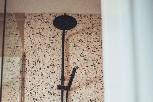 a lamp in a room with a wall with flowers at VIP apartments Bitola in Bitola