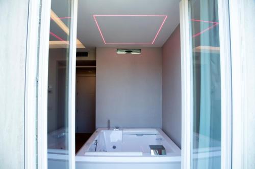 a bath tub in a room with a mirror at Hotel Ristorante Aeclanum in Mirabella Eclano