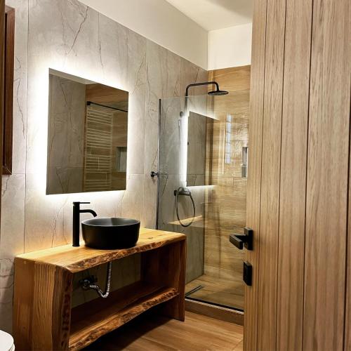 a bathroom with a sink and a shower at Peri Elxis Luxury Suites in Mouresi