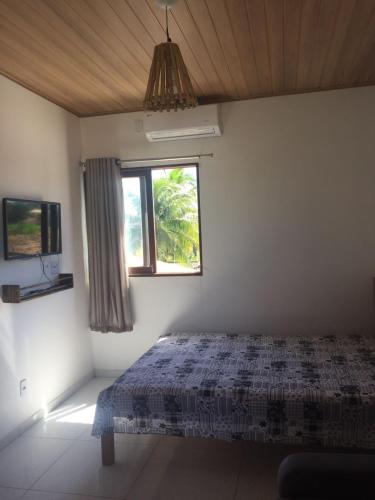 a bedroom with a bed and a window at Casa do Francês Temporada in Marechal Deodoro