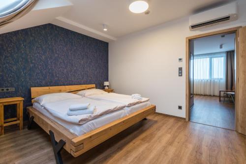 a bedroom with a large bed in a room at Adalbert penzion Čejkovice in Čejkovice