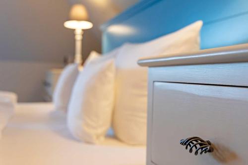 a bed with a night stand with a zebra on it at Romantik Hotel Friederikenhof Hotel Restaurant & Spa in Lübeck