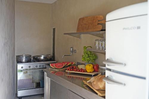 a kitchen with a counter with fruits and vegetables on it at Villa Dolce Bellezza in Salò