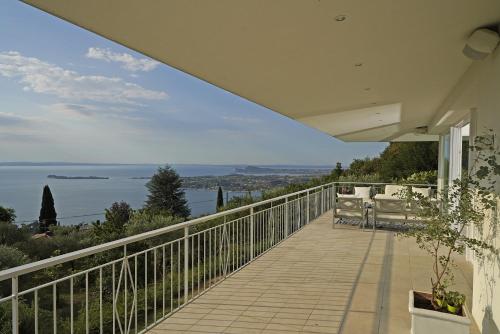 a balcony of a house with a view of the ocean at Villa Dolce Bellezza in Salò