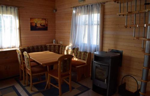 a dining room with a table and a stove at Ruheoase in Wolfern, zw. Wien & Salzburg in Maria Laah