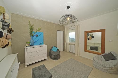 a bedroom with a bed and a dresser and a mirror at Villa Dolce Bellezza in Salò