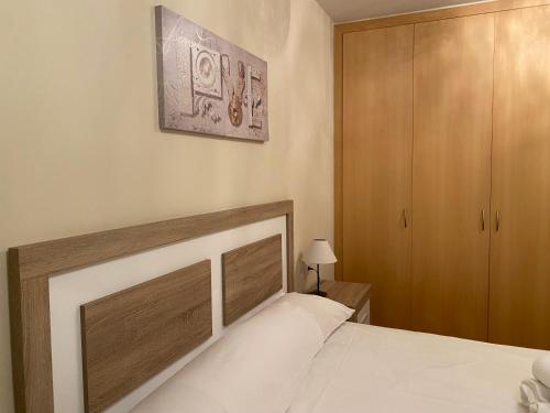 卡尼略的住宿－Canillo L'Areny Star，一间卧室配有一张床和一个木制橱柜