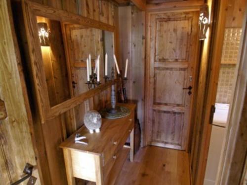 a wooden room with a wooden table and a door at Chalet Enchastrayes, 5 pièces, 10 personnes - FR-1-165A-20 in Enchastrayes