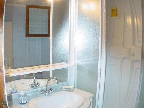 a bathroom with a sink and a shower with a mirror at Chalet Barcelonnette, 4 pièces, 8 personnes - FR-1-165A-69 in Barcelonnette