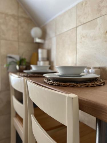 a kitchen with a counter with plates on it at The Clontarf in Llandudno