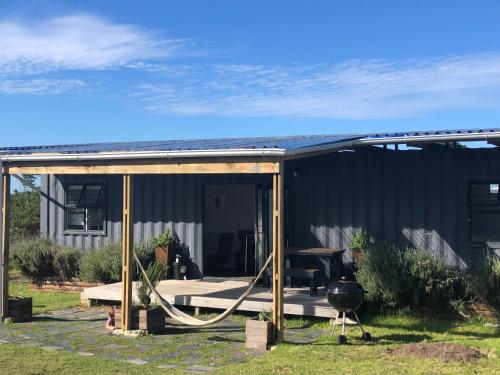 a screened in porch of a house at Casetta del Fuoco - Eco Container Cottage in Plettenberg Bay