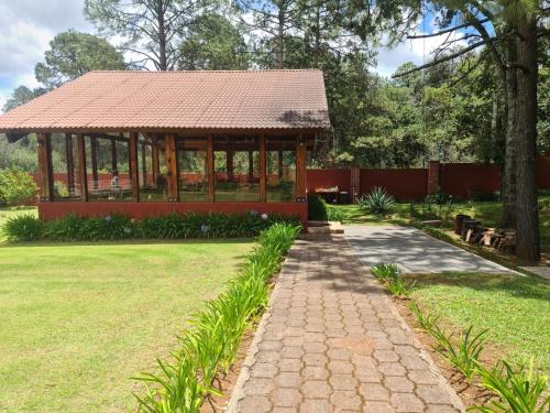 a gazebo in a park with a grass field at Finca Los Angeles Hospederia & Sociales in Huasca de Ocampo