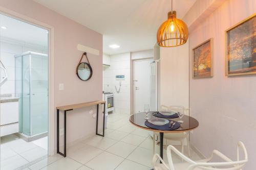 a kitchen and dining room with a table and chairs at Beach Class Santa Maria by Easy Home in Recife