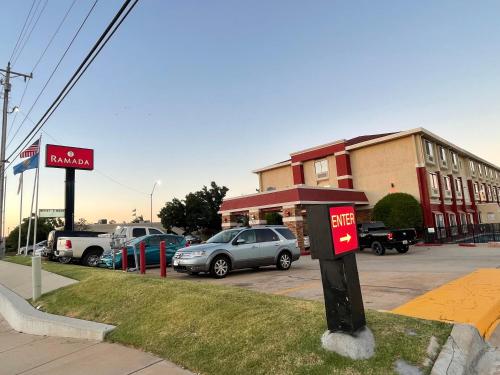 a parking lot with a red mailbox in front of a building at Ramada by Wyndham Oklahoma City Airport North in Oklahoma City