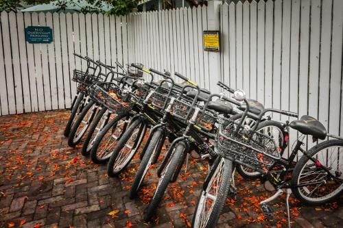 a row of bikes parked next to a fence at Courtney's Place Historic Cottages & Inns in Key West