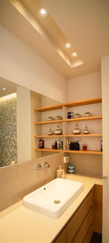 a bathroom with a sink and a mirror at Sea front panoramic duplex roof-top in Herzliya
