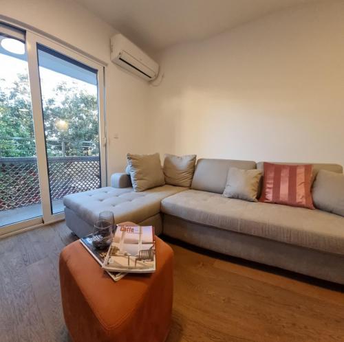 a living room with a couch and a table at Old town Apartments in Herceg-Novi
