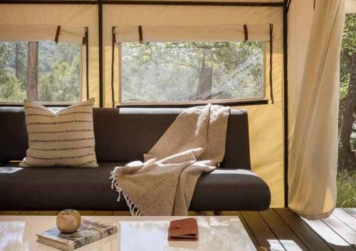 a living room with a couch and a window at AutoCamp Catskills in Saugerties