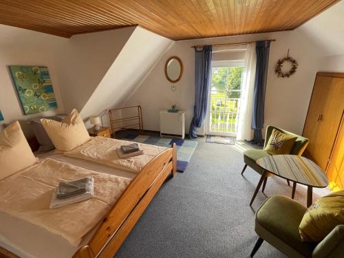 a bedroom with a bed and a couch and a table at Apartment Moselblick in Ürzig
