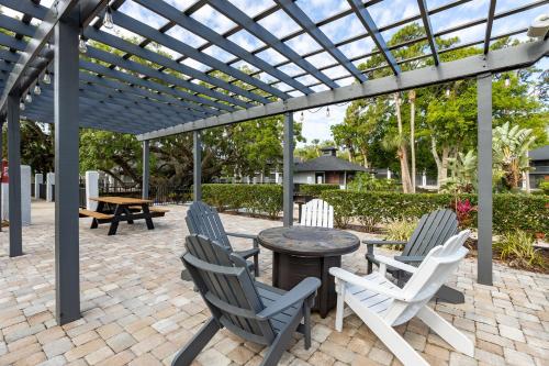 a patio with chairs and a table under a pergola at Legacy Vacation Resorts - Palm Coast in Palm Coast