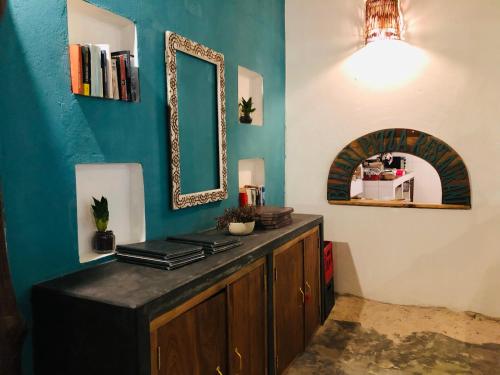 a bathroom with a mirror and a wooden cabinet at Bahari Beach Bungalows in Jambiani