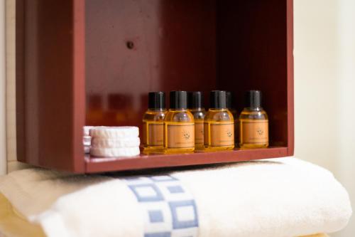 a shelf with four bottles of oils on it at CedarTREE Prishtina in Prishtinë