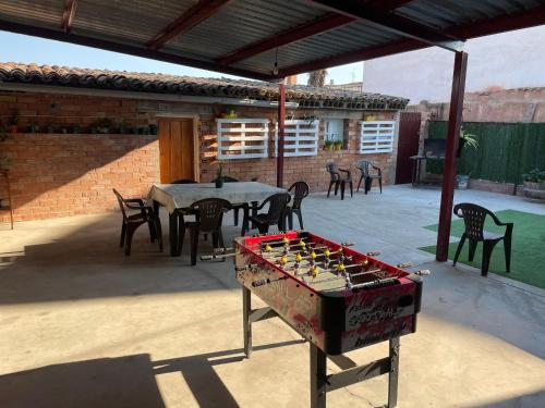 a table and chairs on a patio with a game on a table at Casa La Fuente in Huércanos