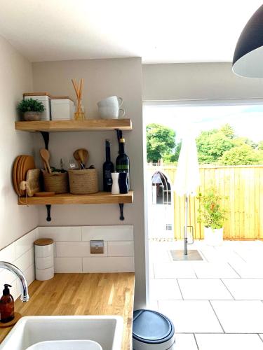 a kitchen with a sink and a counter with a window at The Nest in Sway