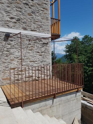 a balcony with a swing on the side of a building at Graziosa, Casetta in Valgerola in Rasura