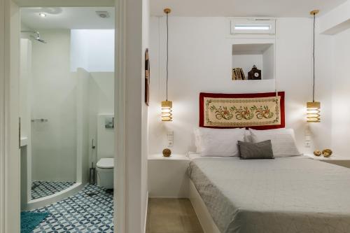 a bedroom with a bed and a bathroom with a toilet at Skopelitian Relaxing House in Skopelos Town