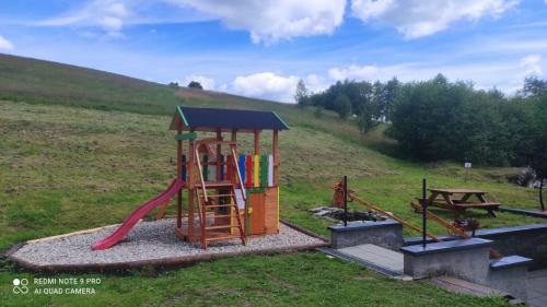 a playground with a slide in a field at Penzion Štvanice in Staré Město