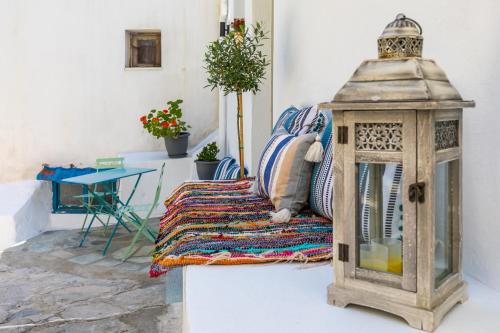 a room with a bed with a lantern and a table at Skopelitian Relaxing House in Skopelos Town