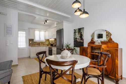 a kitchen and dining room with a table and chairs at Skopelitian Relaxing House in Skopelos Town