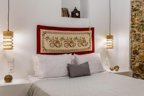 a bedroom with a bed with a picture above it at Skopelitian Relaxing House in Skopelos Town
