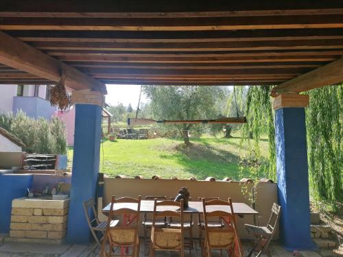a table and chairs on a patio with a view of a field at Agriturismo Campolungo in Sant'Ermo