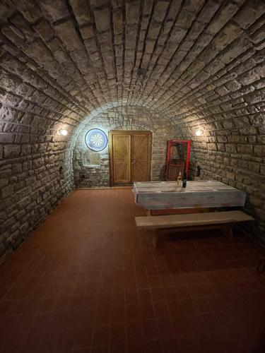 a bathroom with a tub in a stone wall at Chill Apartman in Balatonfüred
