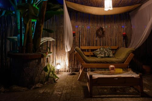 a living room with a couch and a plant at Katsaros Studios & Apartments in Sidari