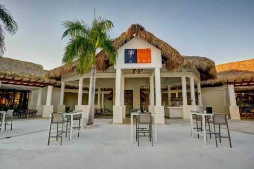 a restaurant with tables and chairs in front of a building at Royalton Splash Punta Cana, An Autograph Collection All-Inclusive Resort & Casino in Punta Cana
