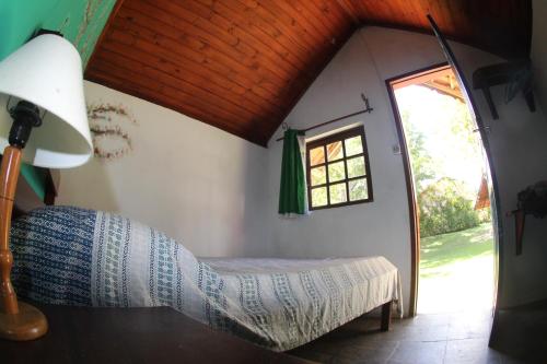 a bedroom with a bed in a room with a window at "Brilho do Sol" in Lumiar