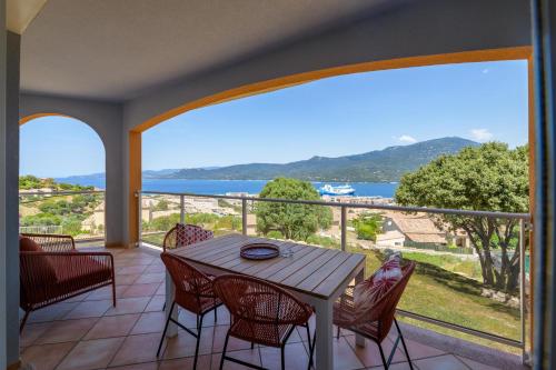 a balcony with a table and chairs and a view of the ocean at Résidence Ochji di Mare in Propriano