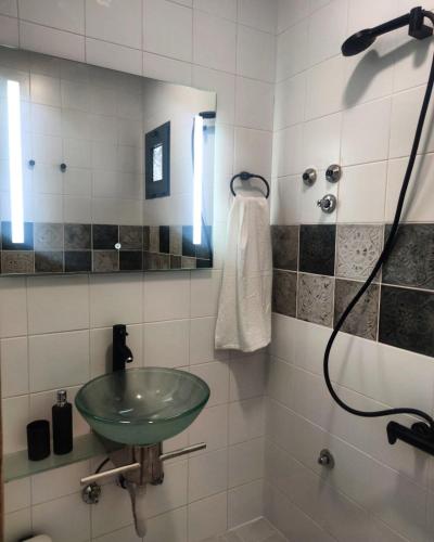 a bathroom with a green sink and a shower at Anchor house in Volos